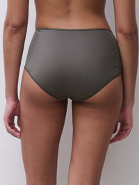 Person wearing olive green underwear on a plain background