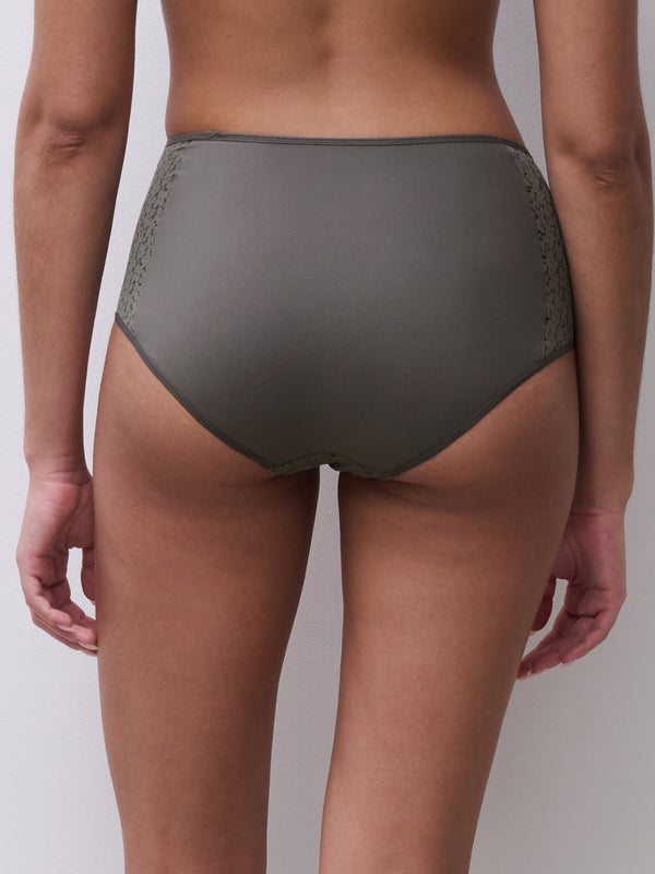 Person wearing olive green underwear on a plain background
