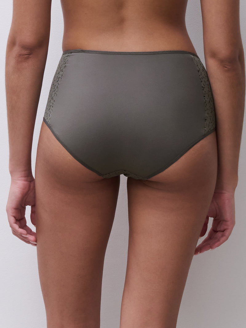 Person wearing olive green underwear on a plain background
