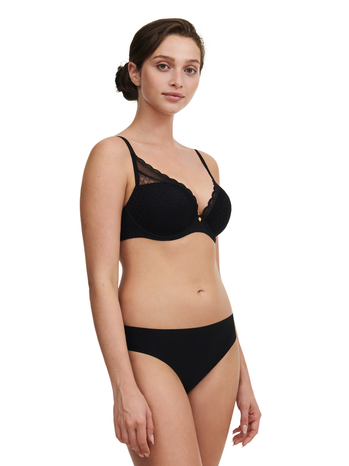 Woman wearing a black bra and panty set on a white background