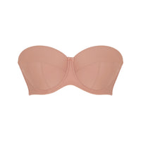 Beige strapless bra on a white background