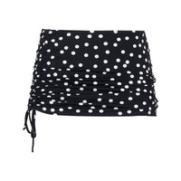 Black skirt with white polka dots on a white background
