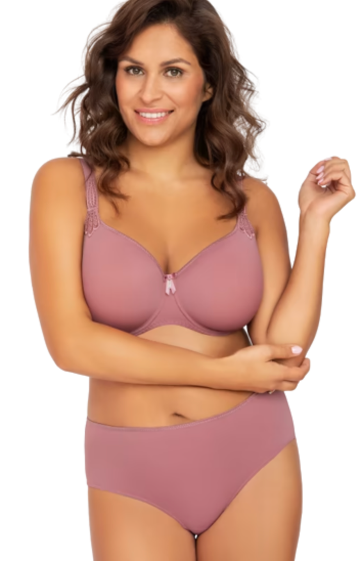 A woman modeling a dusty rose two-piece lingerie set consisting of a bralette with lace straps and a matching high-waisted brief, set against a plain white background.