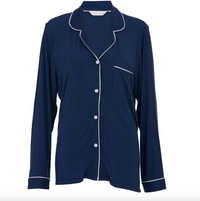 Navy blue pajama top with white piping on a white background