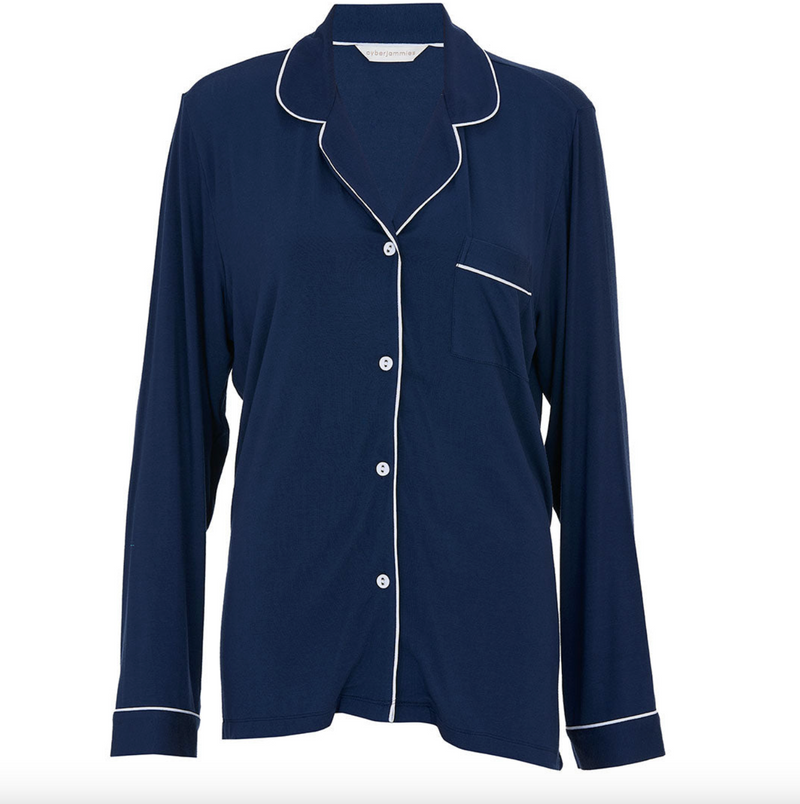 Navy blue pajama top with white piping on a white background