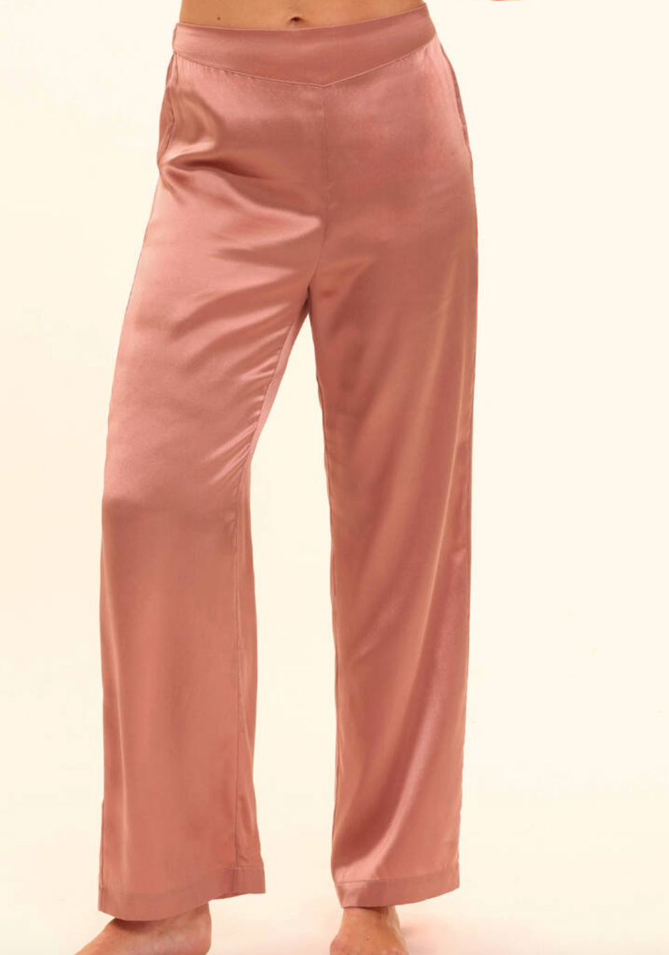 Pink silk pants on a plain background