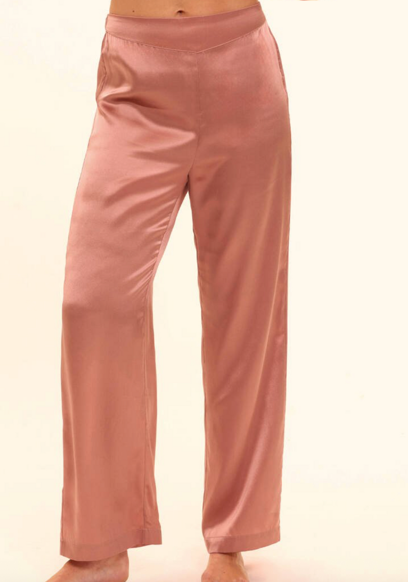 Pink silk pants on a plain background