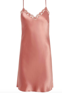 Pink silk slip dress with lace details on a white background