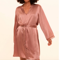Pink silk robe with lace cuffs on a beige background