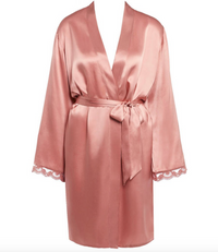 Pink silk robe with lace cuffs on a white background