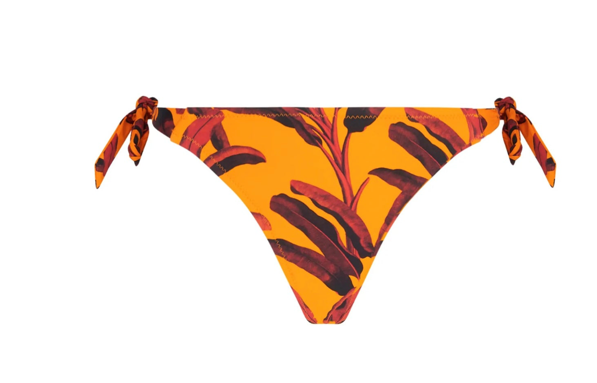 Bikini bottom with orange and brown leaf pattern on a white background