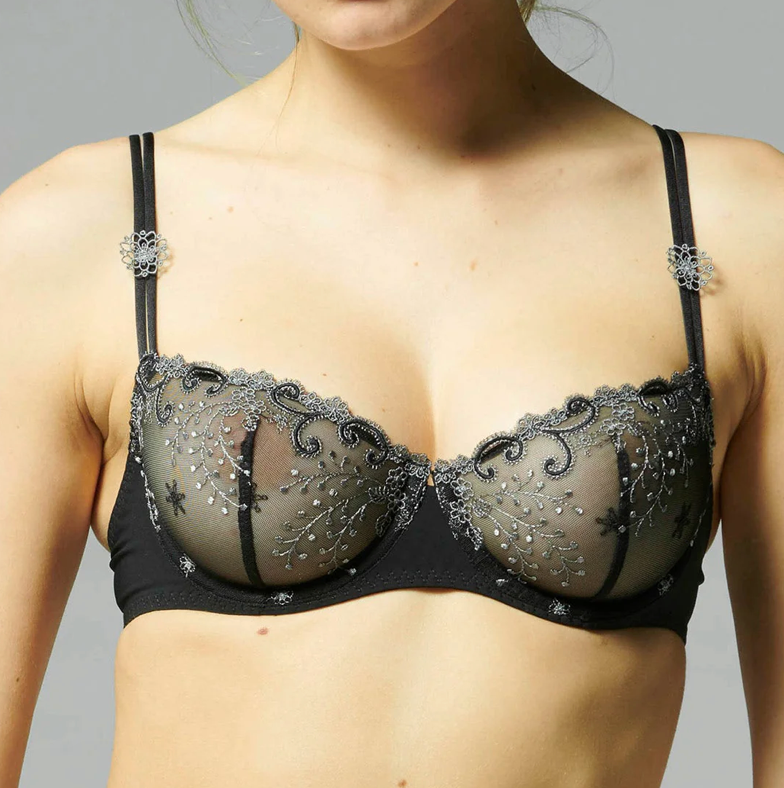 Black bra with intricate silver detailing on a neutral background