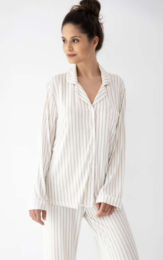 Woman wearing a white and gray striped pajama set on a white background