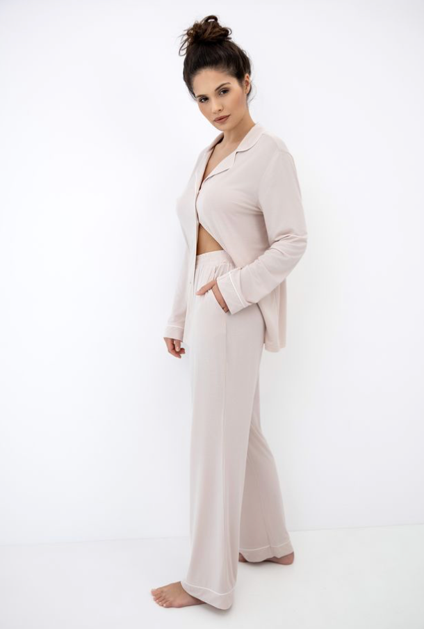 Woman wearing a light pink outfit on a white background