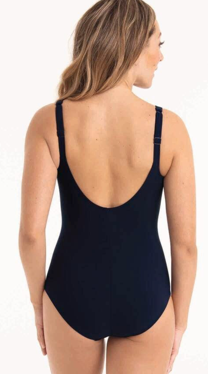 Navy blue swimsuit worn by a model on a white background