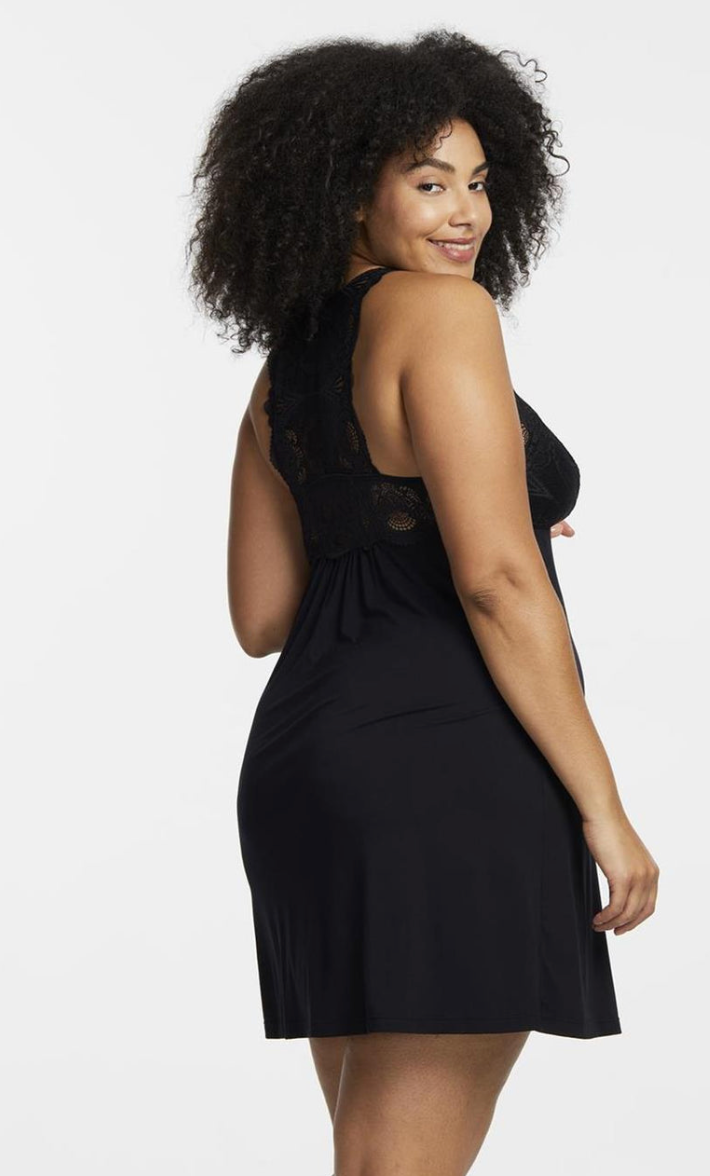 Woman wearing a black dress with lace details on a white background