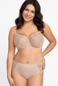Woman wearing a beige bra and panties set on a white background