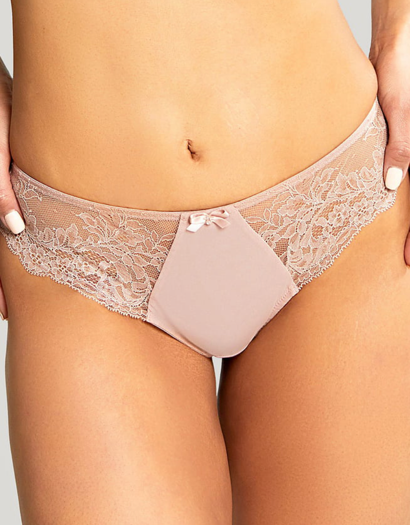 Lace underwear worn by a person on a plain background