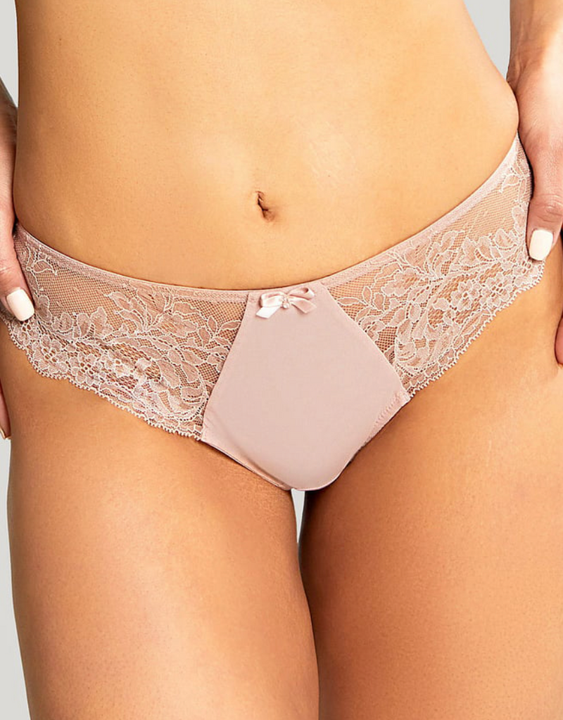 Lace underwear worn by a person on a plain background
