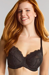 Woman wearing a black bra against a neutral background