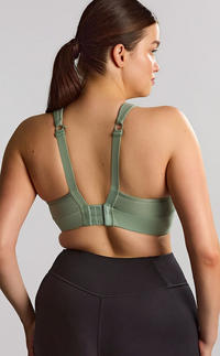 Woman is wearing a pale green sports bras. 