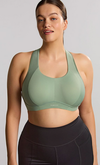 Woman is wearing a pale green sports bras. 
