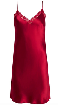 A red silk slip dress with thin straps and a lace-trimmed V-neckline, shown against a plain white background.