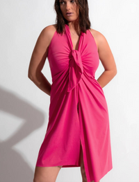 Woman wearing a pink dress against a white background