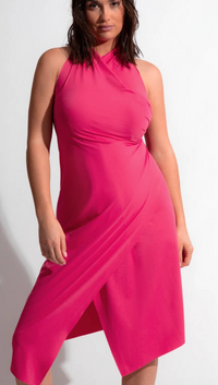 Woman wearing a pink dress against a white background