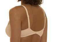 Beige bra worn by a person on a white background