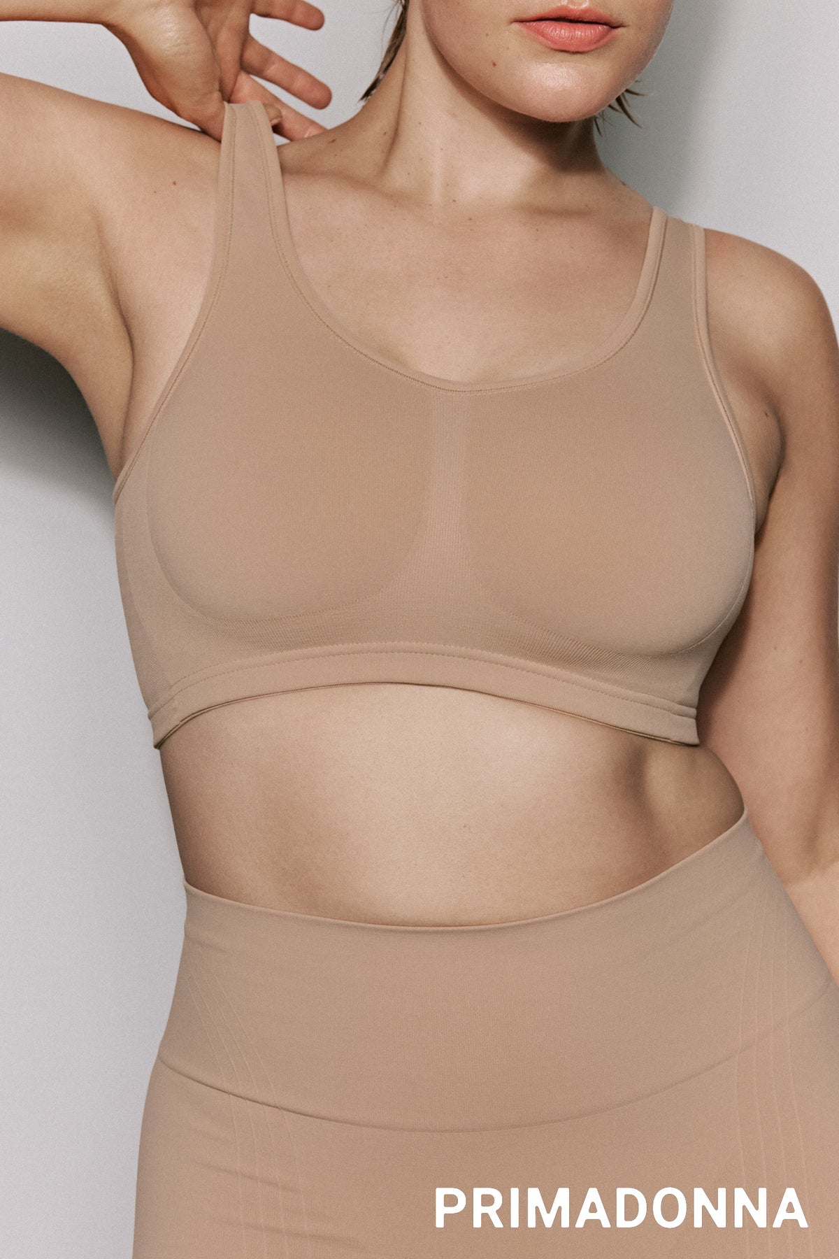 Beige wireless bra and short set with 'Primadonna' branding on a light gray background
