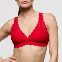 Red lace bra on a plain background