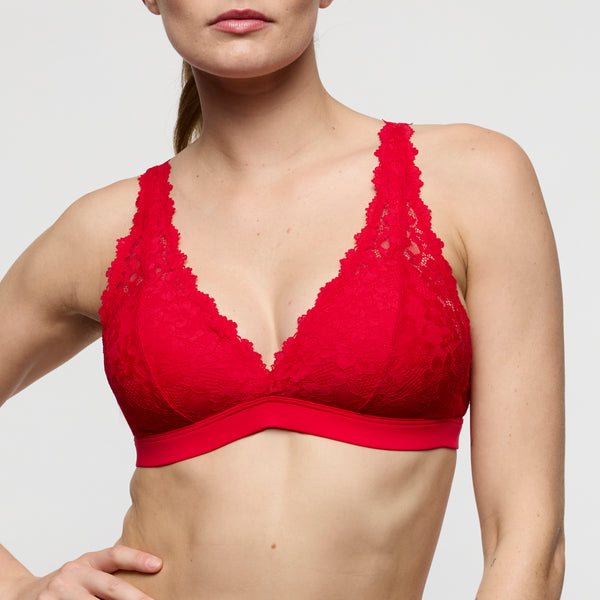 Red lace bra on a plain background