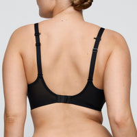 Black bra worn by a person on a plain background