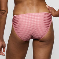 Person wearing a pink checkered underwear on a plain background