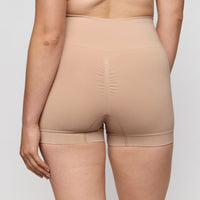 Beige shapewear worn by a person on a plain background