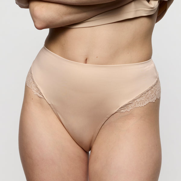 Beige lace underwear on a plain background