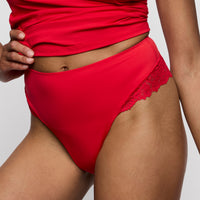Red Thong with lace details on a plain background