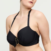 Black bikini top with a gold buckle on a white background