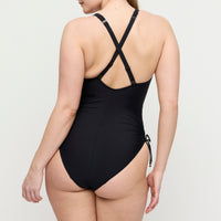 Black swimsuit with criss-cross back design on a white background