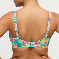 Multicolored bikini top on a plain background