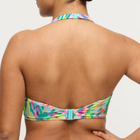 Multicolored bikini top worn by a person on a plain background