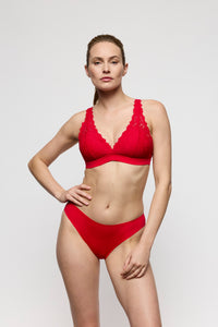 Woman wearing a red bikini against a plain background