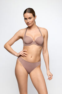 Woman wearing a beige bikini set on a white background