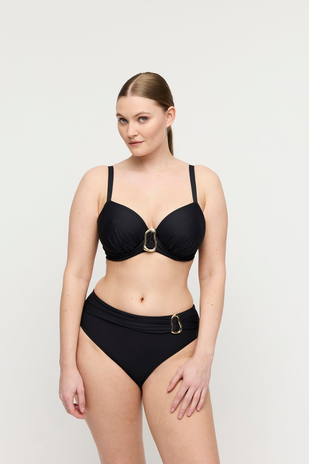 Woman wearing a black bikini on a white background