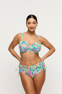 Woman wearing a colorful bikini set on a white background