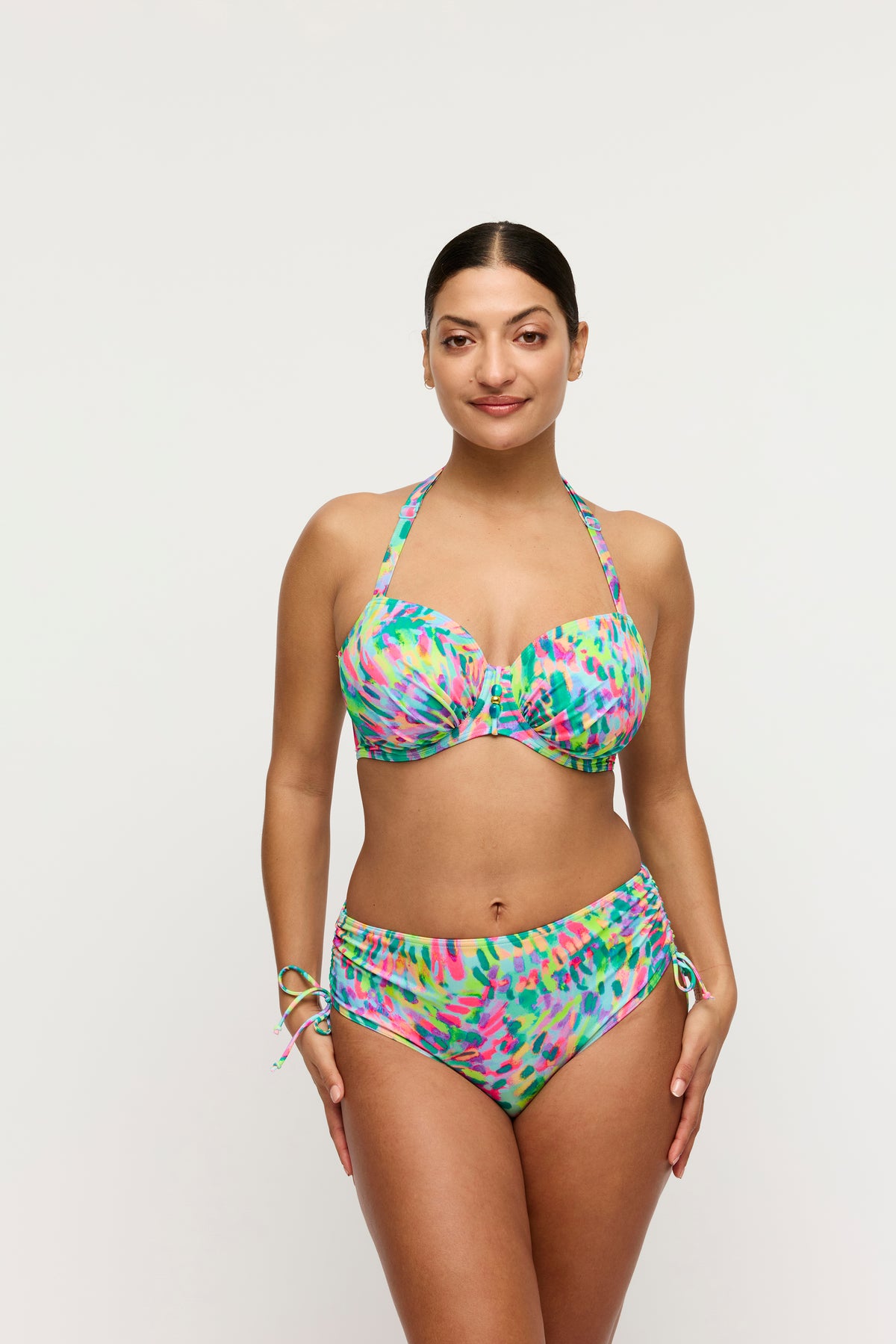 Woman wearing a colorful bikini set on a white background