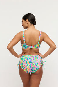 Woman wearing a colorful bikini set on a white background